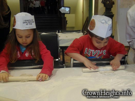 Jayden and Joshual roll out their matzah dough at the Living Legacy Matzah Bakery.