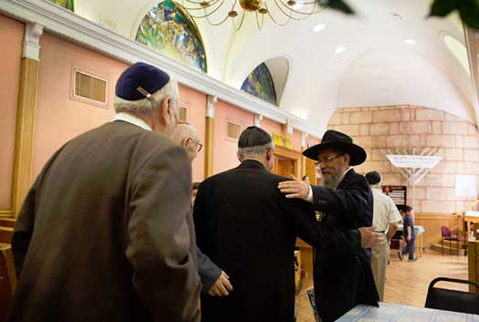 Rabbi Naftali Estulin, right, greeting Red Army veterans at a Chabad center in California.