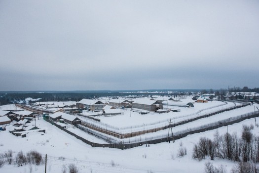 The prison and environs in winter. Guards are allowed to shoot an escaping prisoner after he has crossed the middle wooden fence.