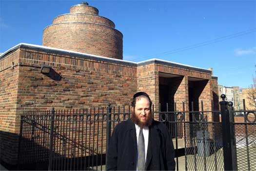 Rabbi Baruch Hertz poses for a photo outside of Congregation Bnei Ruven in West Rogers Park. Hertz, an Orthodox rabbi, walks about 5.5 miles from Chabad of Lakeview to West Rogers Park a few times a month during the Sabbath, when driving is prohibited. Photos were not allowed to be taken of the rabbi's walk because using electronics also is prohibited on the Sabbath.