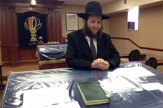 Rabbi Baruch Hertz poses for a photo in the shul at Congregation Bnei Ruven in West Rogers Park. Hertz, an Orthodox rabbi, walks about 5.5 miles from Chabad of Lakeview to West Rogers Park a few times a month during the Sabbath, when driving is prohibited. Photos were not allowed to be taken of the rabbi's walk because the use of electronics also is prohibited on the Sabbath.
