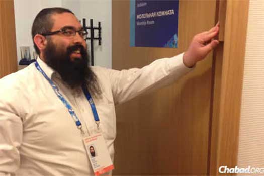 Rabbi Ari Edelkopf affixes a mezuzah at one of the two temporary Chabad Houses strategically placed near the 2014 Olympic Games.