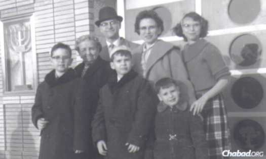 Fisher and his family in front of Talmud Torah Ohev Shalom in the Canarsie neighborhood of Brooklyn.