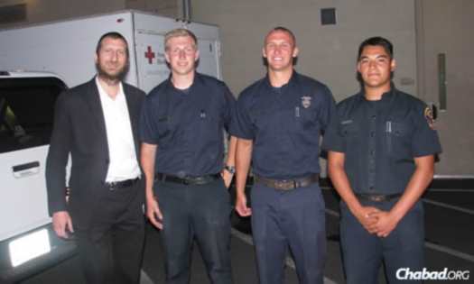 Rabbi Yair Yelin—who co-directs Chabad Alef Center in San Marcos, Calif., with his wife Chanie, and who also works with students at California State University, San Marcos—takes a brief time-out with firefighters.