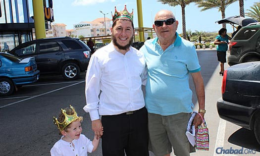 Purim came to the islands in royal form: Rabbi Blasberg and his son deliver mishloach manot gifts of holiday treats.