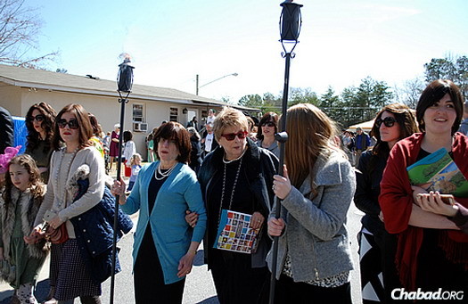 Women march in the procession holding torches. Rashi's mother, Sara Lieberman, in the blue sweater, spoke at the event, describing some of the many ways she interacted and learned from her daughter.