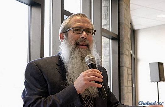 Rabbi Avrohom Grossbaum, director of Lubavitch of Indiana. welcomes guests to the building's grand opening. For three decades, he and his wife, Nini, have run services, programs and classes in Indianapolis from their home and from neighboring Jewish institutions. (Photo: Scott Romer Photography)