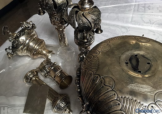 The recovered items include two silver rimonim (crowns for the Torah scrolls) and some smaller pieces that had originally been melded onto the silver breastplate, though the breastplate itself was not found. Nothing was in usable condition.