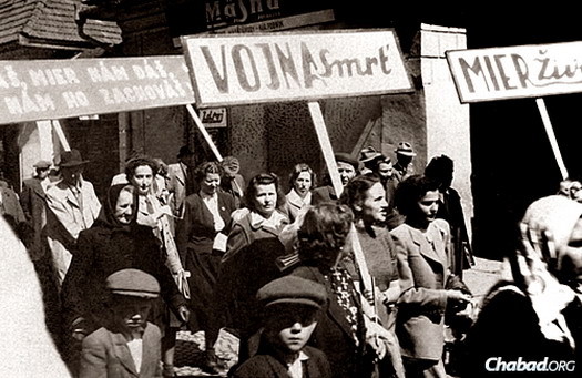 Pasternak's mother can be seen in the center, holding a sign, in the city of Prešov after the war.