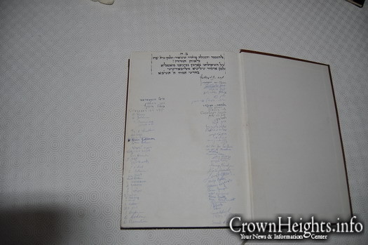 A signed Gemorah by all the members of the first charter flight to New York, with the Rebbe's signature on top.