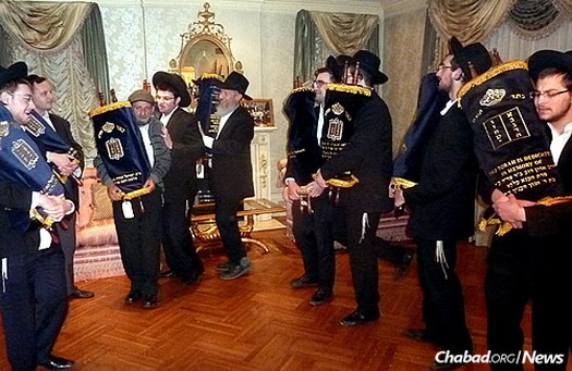 Dancing with the Torahs, some of which will stay in the United States; others will be sent to Paris, Argentina and Canada.