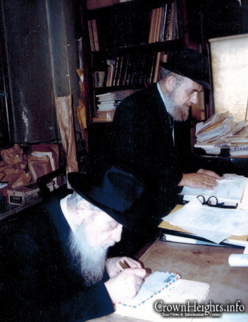 Rabbi Nissan Mindel at work in the 770 Office, alongside Rabbi C.M.A. Chodakov, OBM.