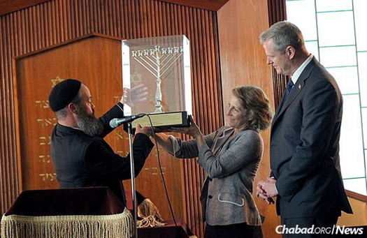 The rabbi presents Massachusetts Gov. Charlie Baker and first lady Lauren Baker with the Lamplighter Award and a menorah at Chabad of the North Shore’s 23rd anniversary gala.