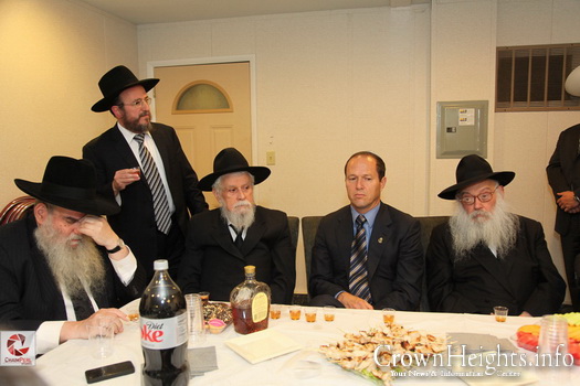 Rabbi Binyomin Klein sitting to the right of then Jerusalem Mayor Nir Barkat at a Farbrengen at the Ohel.
