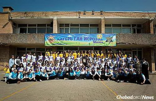 A group photo of the girls' division in Gan Israel Moscow. The campgrounds are those of a former Young Pioneer Organization camp, which among other things featured a monument to Grigol Ordzhonikidze, a Georgian Bolshevik leader who, together with Joseph Stalin and Armenian Anastas Mikoian, were known as the “Caucasian Trio.” The statue was removed after the campsite was purchased for Gan Israel.