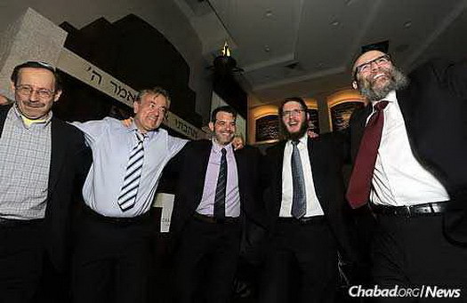 Rabbi Flinkenstein, right, dances with some of the dinner guests.