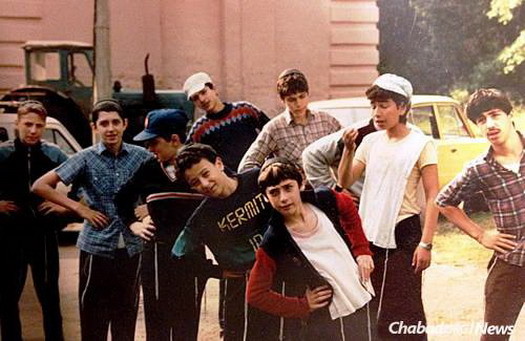 Camp Gan Israel Moscow in 1990 did not take place at a camp grounds, but at a school facility. Kipah-clad and tzitizit-wearing campers perform morning exercises at lineup.