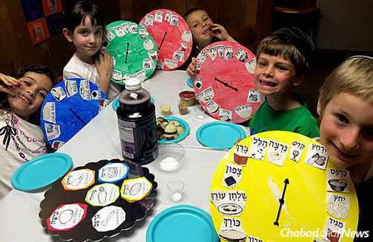 Children at Chabad show off their Passover seder plate dials.