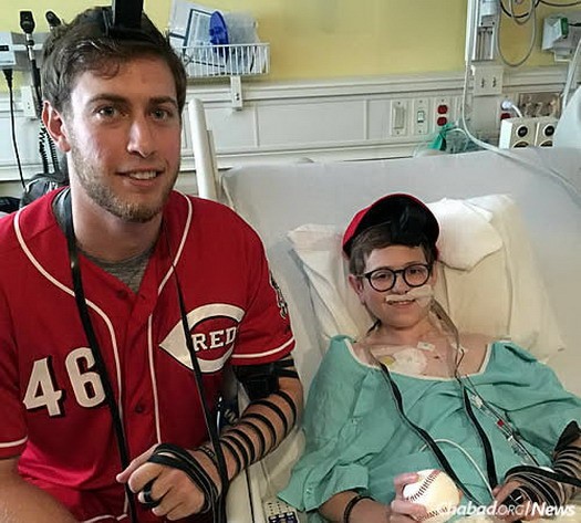 Jon Moscot, a rookie pitcher for the Cincinnati Reds, wrapped tefillin with Avi Newhouse, who is undergoing treatment for a rare form of lymphoma in a Cincinnati hospital.