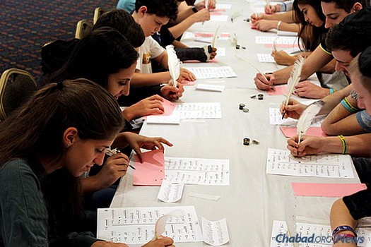 A group of CTeens in South Florida—led by Chabad Rabbi Yossi Denburg, director of CTeen of Boca Raton—is helping to restore a Holocaust-era Torah brought to America from Russia and giving people the chance to buy letters in it. At the kick-off event for the project, participants practice writing with a feather pen and ink, similar to what a scribe would do.