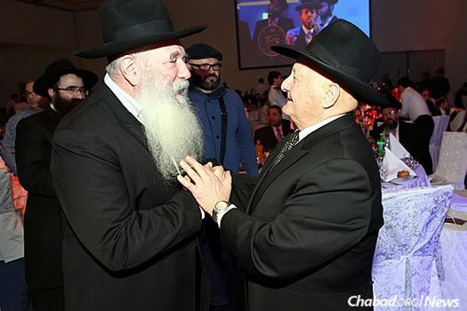 Rabbi Yitzchak Kogan greets Rabbi Berel Zaltsman, who was a member of the undergroundr Chabad community in Samarkand, Soviet Asia, until his emigration in 1972. Zaltsman was a guest speaker at the Moscow 19 Kislev gathering.