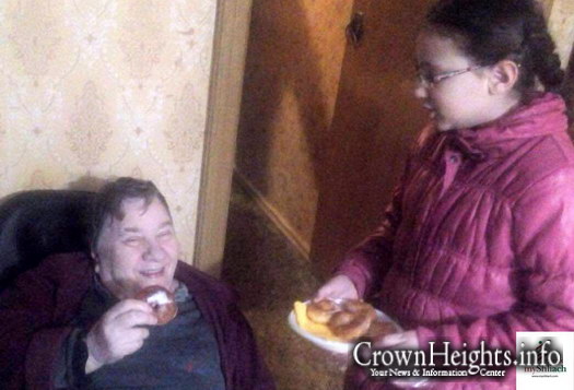 Chani Lipsch of Saratov, Russia giving out doughnuts to seniors