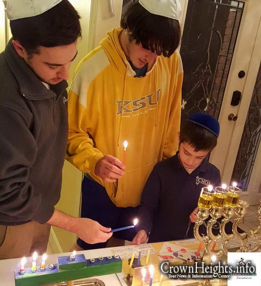 Levi Charytan of Kennesaw, GA lights Menorah with local students