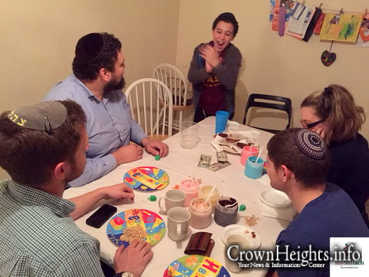 Tzvi Tiechtel of Chabad at ASU runs a game at a small student Chnaukah party​