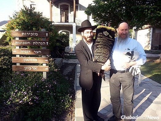 At Kibbutz Degania, Rabbi Yosef Yitzchak (“Fitchi”) Blau, left, director of Chabad at Kibbutz Kinneret who has also been serving Degania, stands with Bentzion Chanowitz, administrator of the Beis Yisroel Torah Gemach in Brooklyn, N.Y., a project of Merkos Suite 302.
