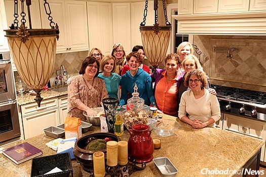 Participants in the monthly “Loaves of Love” program, where women learn how to make challah, pray and say a blessing for others, and then share their finished product with someone in the community.