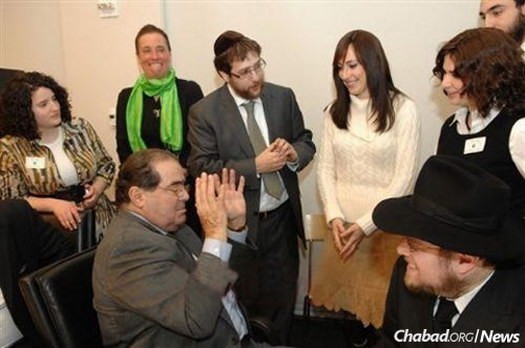 Scalia with students and Rabbi Noach Heber, center, program director, and Rabbi Yehoshua Metzger, right, co-director of Chabad Lubavitch of Midtown Manhattan, at a 2009 daylong conference of the Institute of American and Talmudic Law held at the Chabad center.