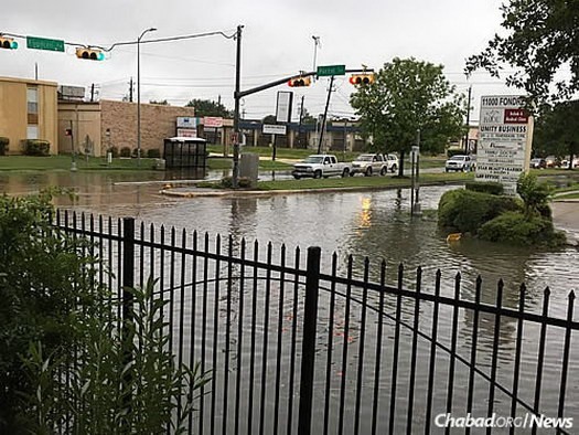 Chabad of Houston is working to provide aid to those affected by the flooding, including inviting all those who need to attend the Passover seder. Here, water swirls in front of the Chabad Lubavitch Center in Fondren Southwest. 