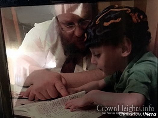 Rabbi Mendel Samuels—co-director of Chabad of the Farmington Valley in Weatogue, Conn., with his wife, Blumie—studies with his youngest child, Meir, who has a rare genetic disease called Familial dysautonomia.