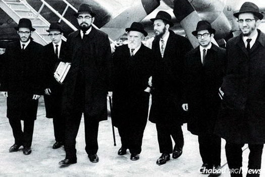The first shluchim with Rabbi Eliyahu (Yaichel) Simpson, center, at the airport