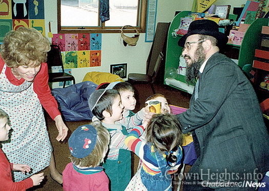 The Fellers help children in the cheder perform the mitzvah of tzedakah.