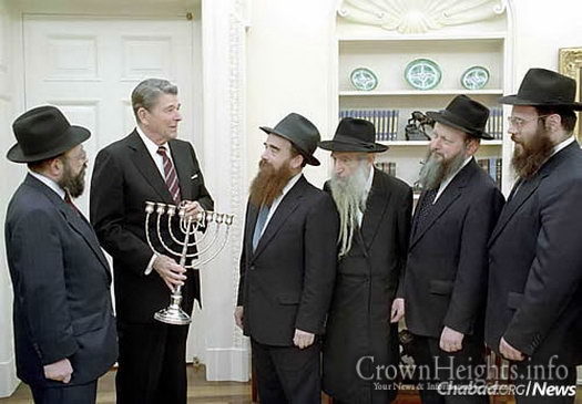 With President Ronald Reagan in the White House at Chanukah time are, from left: Rabbi Moshe Feller, Rabbi Avraham Shemtov, Rabbi Shmuel Dovid Raichik, Rabbi Moshe Herson and Rabbi Yossi Groner.