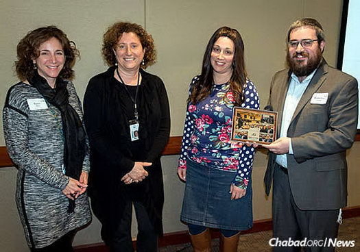 From left: Karen Sher and Marci Mayer Eisen of the Jewish Federation of St. Louis pay tribute to Landa, shown here with his wife, Rivka, on the completion of his two years as president of the local Jpro organization.