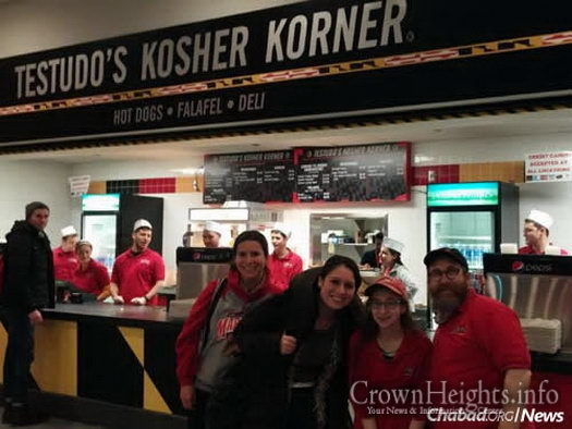 Alumni Tamar May and Rachel Rosner return to the University of Maryland for a game and to visit Rabbi Eli Backman, co-director of the Bais Menachem Chabad Jewish Student Center, at the kosher food stand with his daughter, Chaiky.