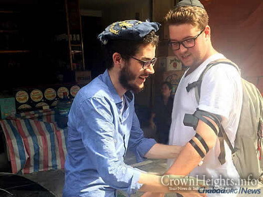 The word “Shalom!” called out from a rickshaw alerted Dubinsky, left, that there was a Jewish person inside, who got out and put on tefillin.