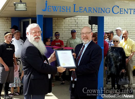The new Jewish Learning Center, or JLC, will offer classes for all ages with a stress on evening adult education. Rabbi Avrohom Litvin, left, regional head Chabad-Lubavitch emissary and co-director of Chabad of Kentucky, accepts a certificate from the mayor’s office on the center’s opening.
